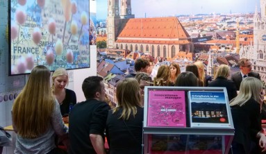 Young people with their backs to the camera at a stand in the ITB Career Center. 