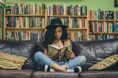 a young woman sitting and reading