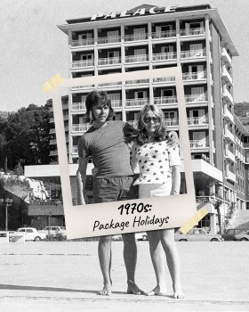 A woman and a man stand arm in arm on a beach in front of a hotel. The moment is captured in a Polaroid frame.