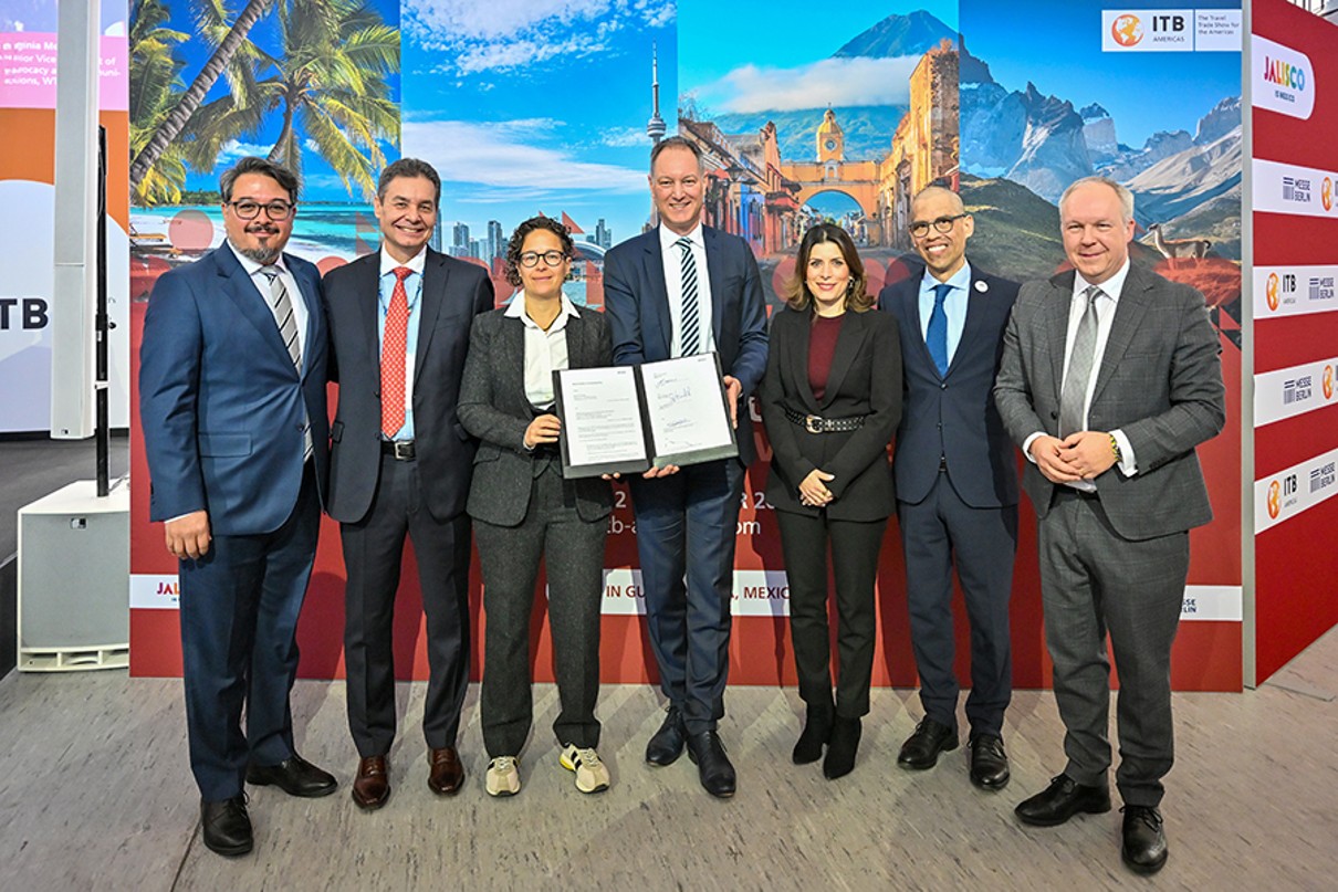 Das Bild zeigt eine Gruppe von sieben Personen, die in einer Reihe stehen und sich für ein Foto präsentieren
