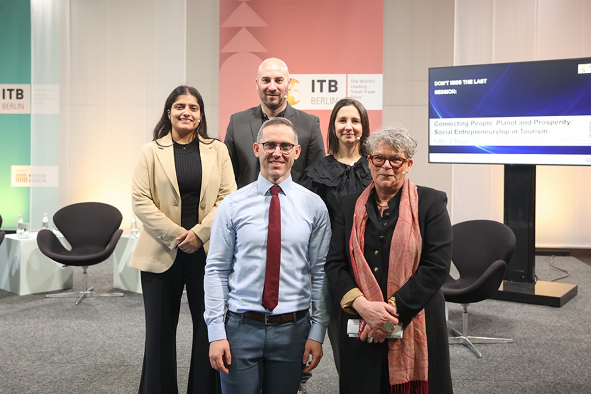 Five people, two men and three women, pose for the camera