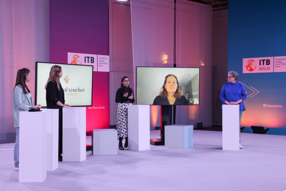 Five Persons on a stage at ITB Berlin. 