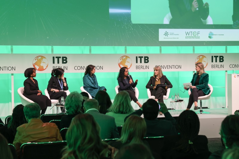 Five panellists on the Green Stage at the ITB Berlin Convention, with the audience in the foreground.